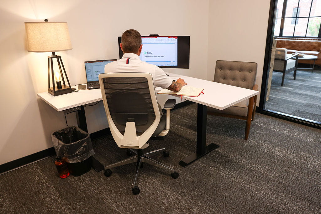Male employee works at his monitor in his office