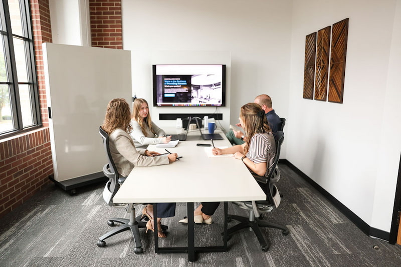4 employees in a conference room