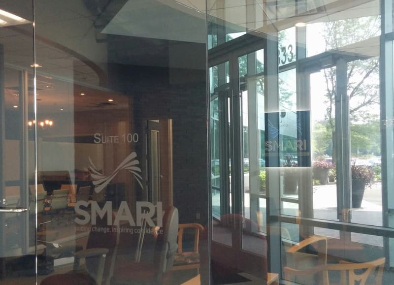 glass doors with the SMARI logo in the office