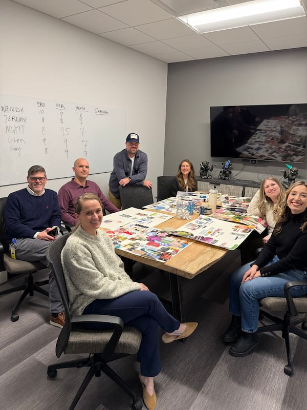 7 SMARI employees working on collages in their conference room